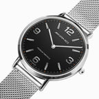A silver-tone Mercedes-Benz AMG analog watch with a black dial and a silver mesh metal bracelet, shown on a clean white background.