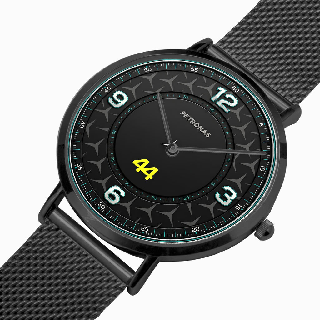 A Petronas wristwatch with a black round case, textured black dial, and matching black mesh strap, featuring white Arabic numerals and a bright yellow '44' on the center.