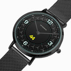 A Petronas wristwatch with a black round case, textured black dial, and matching black mesh strap, featuring white Arabic numerals and a bright yellow '44' on the center.