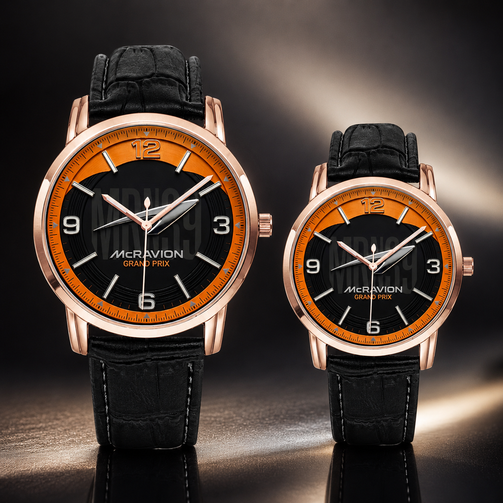 Two McRivion Grand Prix analog wristwatches with black leather straps, rose gold cases, and black dials with bright orange accents, displayed on a reflective dark surface.