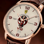 A close-up of a Rossocorsa V12 Championship Glory Team Edition watch with a rose gold case, textured off-white dial, red numerals, and a brown leather strap.