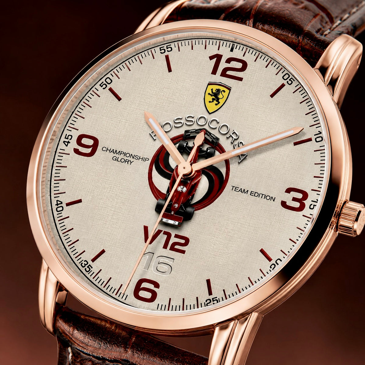 A close-up of a Rossocorsa V12 Championship Glory Team Edition watch with a rose gold case, textured off-white dial, red numerals, and a brown leather strap.