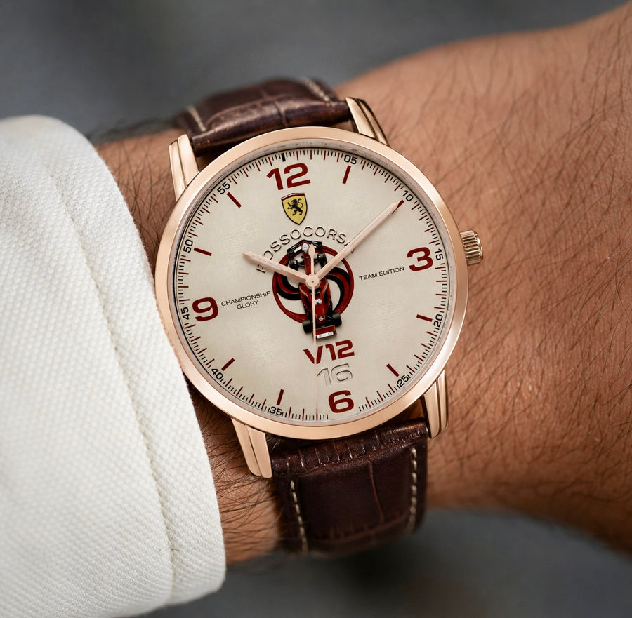 A close-up of a wrist wearing a Joventra Rosso Corsa V12 automatic watch with a rose gold case, brown leather strap, and white dial featuring a racing shield emblem.