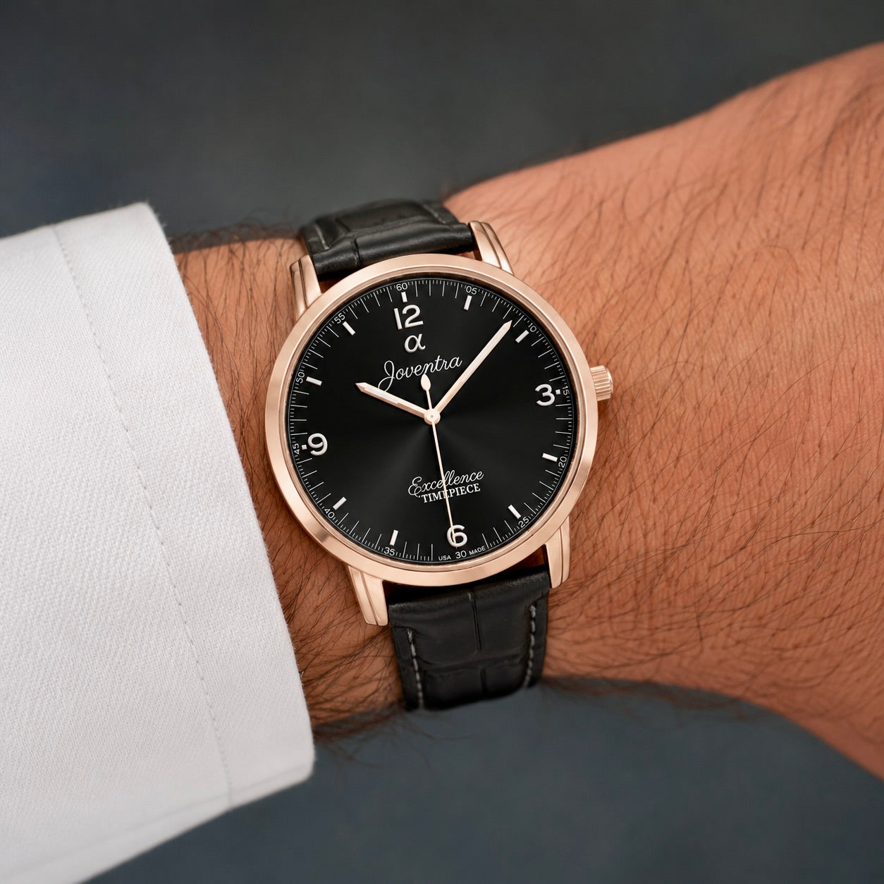 Close-up view of Joventra Excellence black watch dial featuring sunburst finish, silver numerals, and Joventra Alpha logo