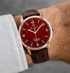 Close-up view of Joventra Classic crimson red watch dial featuring textured crosshatch pattern, silver numerals, and Joventra Alpha logo.