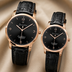 Two matching wristwatches with black leather straps and rose gold cases, displayed on a soft beige fabric background. Both feature black dials with rose gold markers, hands, and the Joventra Excellence Timepiece branding.