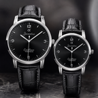 Two Joventra Excellence Timepiece watches with black leather straps and silver-toned cases, displayed side by side against a dark gray background.