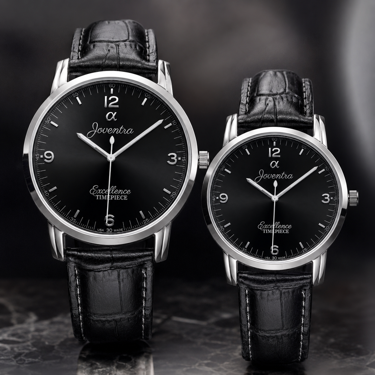Two Jaeger-LeCoultre Excellence Timepiece watches with black leather straps and silver-toned cases, displayed side by side against a dark gray background.