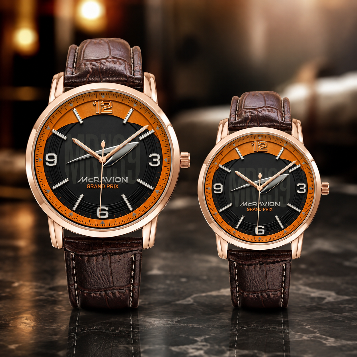 Two McRavion Grand Seiza wristwatches with brown leather straps and rose gold cases, displayed on a dark marble surface with a blurred warm background.