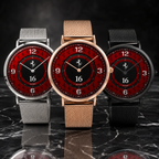 Three Italian motorsport-themed Joventra wristwatches with red dial faces and black numerals, displayed side by side on a dark marble surface. The center watch has a rose gold mesh strap, while the left and right watches have silver and black mesh straps respectively.
