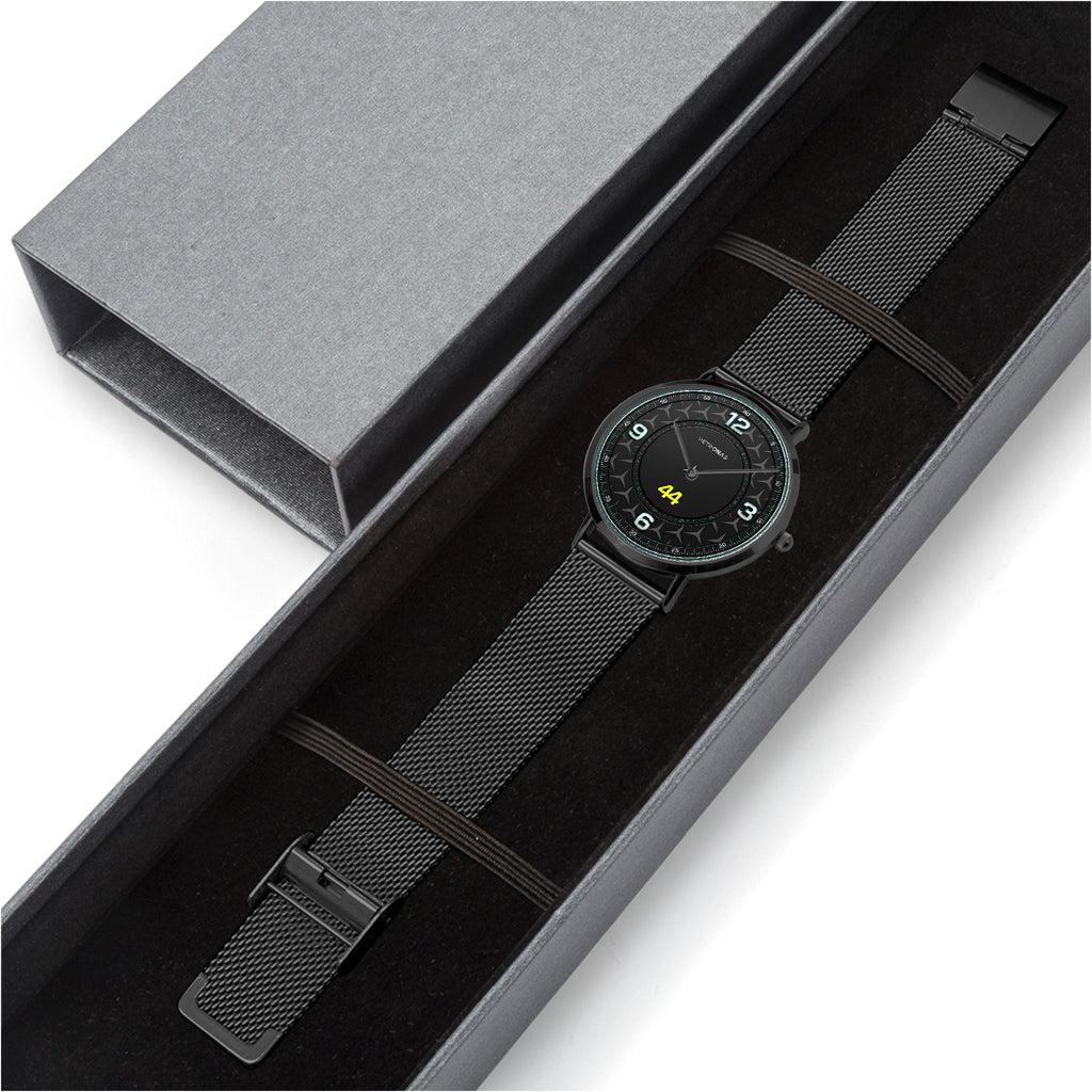 Watch with black mesh strap in a gray box on a white background