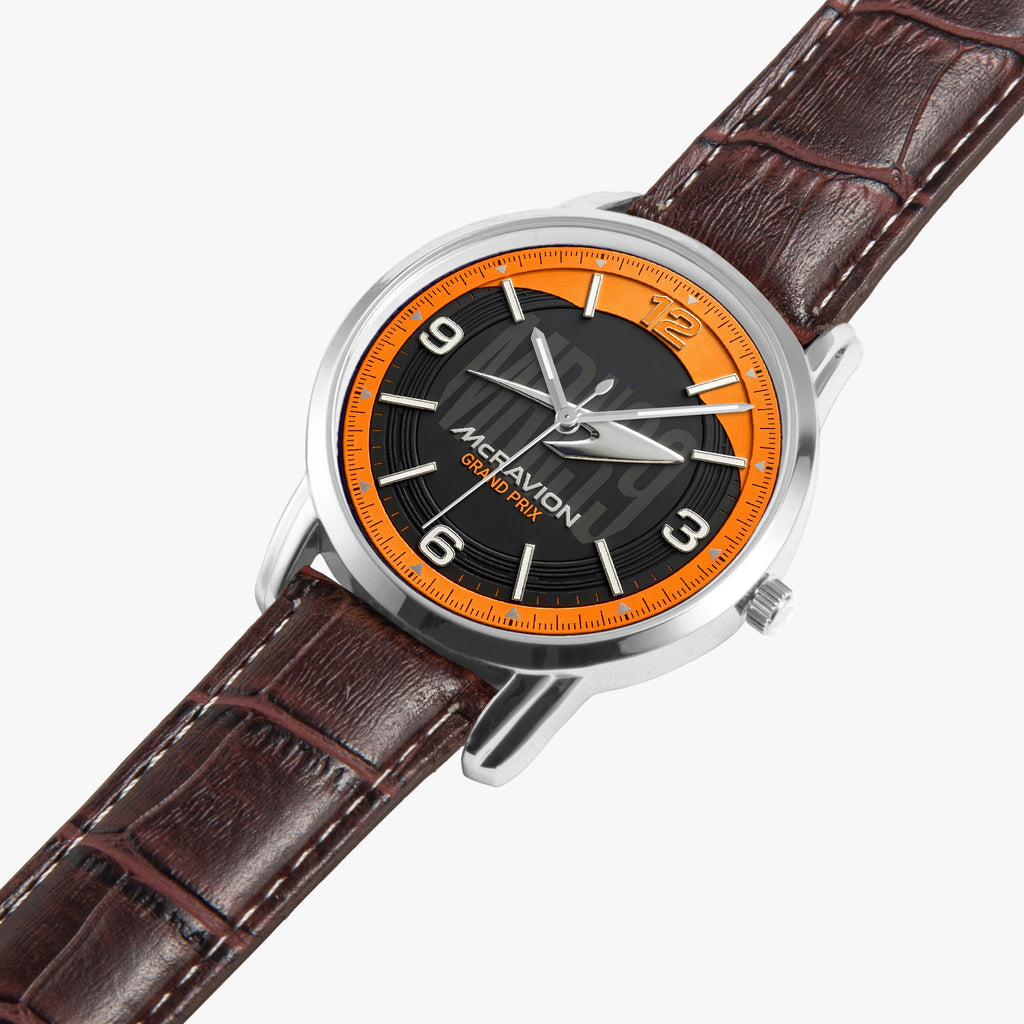 A wristwatch with a brown leather strap, a silver-toned case, and a black dial featuring a bright orange ring around the bezel. The brand name 'MCRAVION' is printed on the dial.