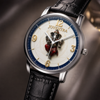 A Joventra wristwatch with a silver-toned case, black leather strap, and a detailed cream dial featuring a central elephant illustration, gold Arabic numerals, and a blue inner ring.