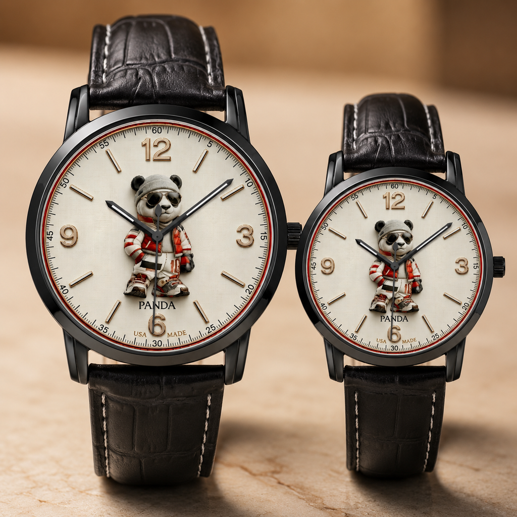 Two wristwatches with black leather straps and round black cases, featuring cream-colored dials with a panda character at the 6 o'clock position and gold Arabic numerals, displayed on a warm beige surface.